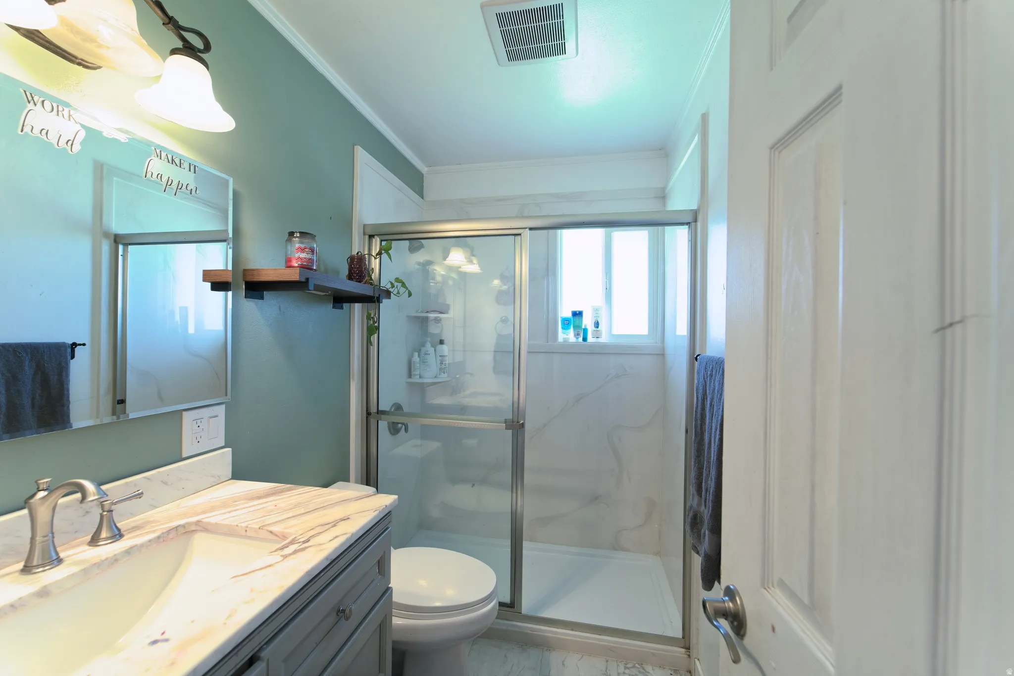 Bathroom featuring a vanity with a stone-finish countertop, undermount sink, and brushed nickel faucet