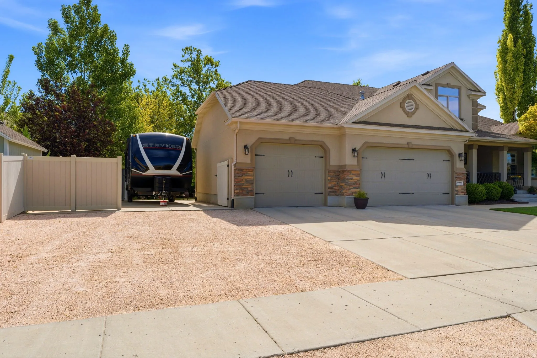 Exterior featuring a three-car garage and 20'x28' RV and toy parking