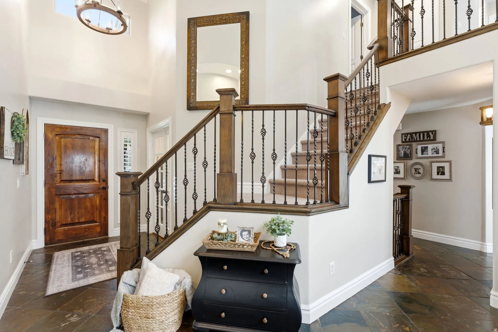 Foyer featuring a grand staircase and two doorways to the the office / den