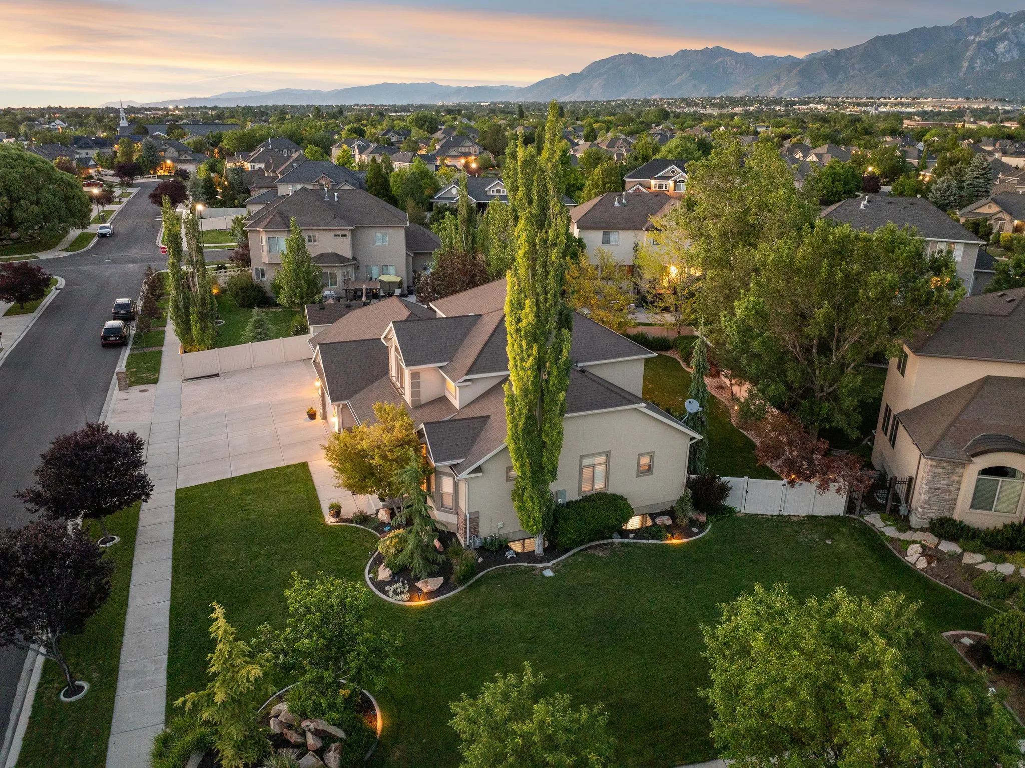 Expansive property featuring mature landscaping and a large driveway