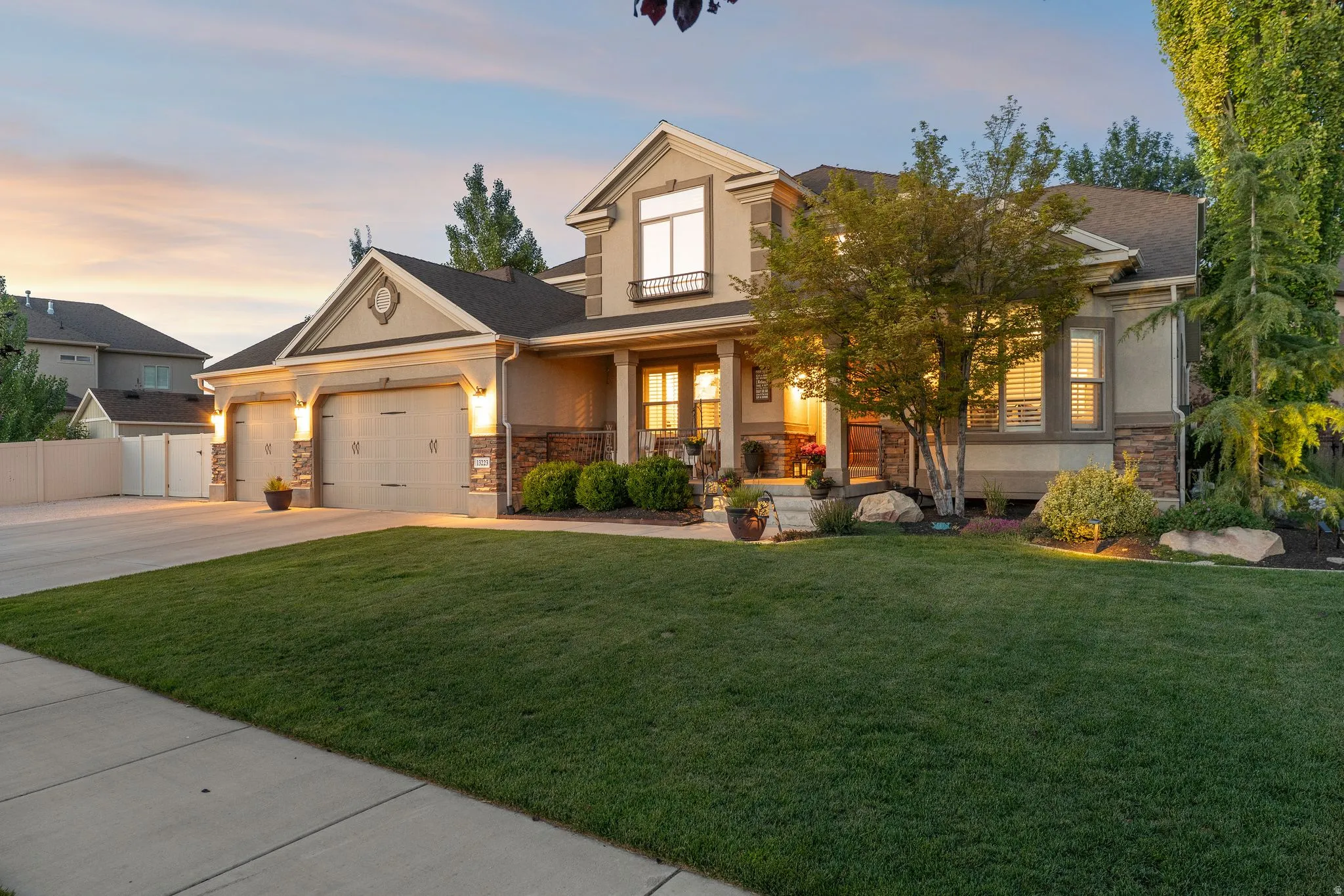 Exterior front entry, established landscaping, and a three-car garage plus AV and toy parking