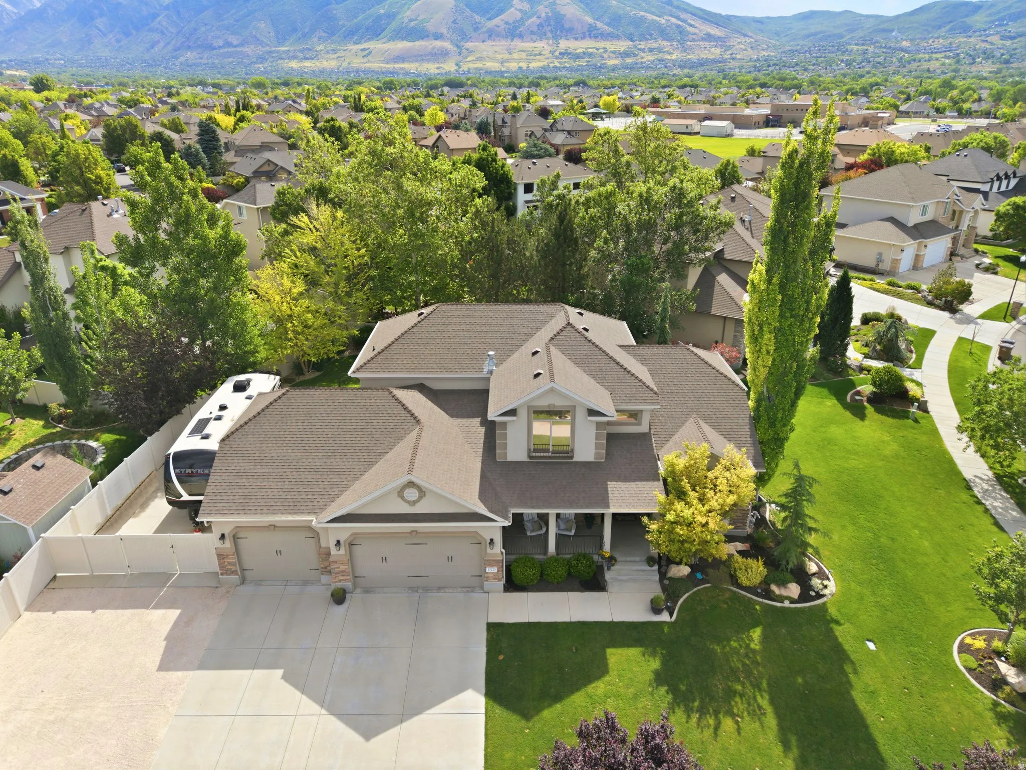 Property featuring a three-car garage with 20'x48' RV and toy parking