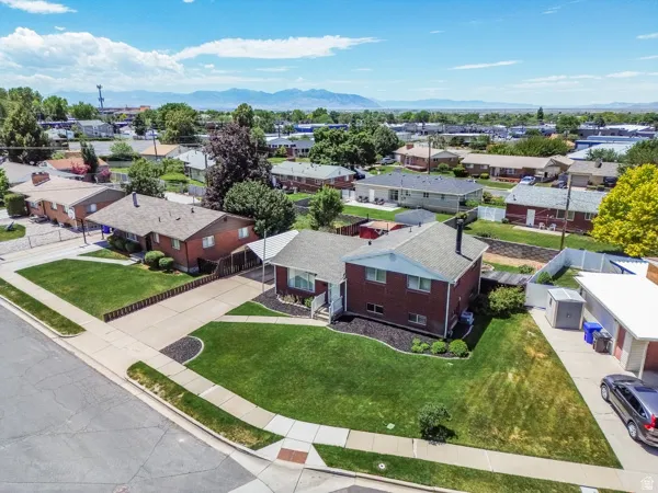 Corner lot property featuring a red brick exterior with white trim