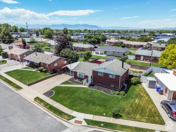Corner lot property featuring a red brick exterior with white trim