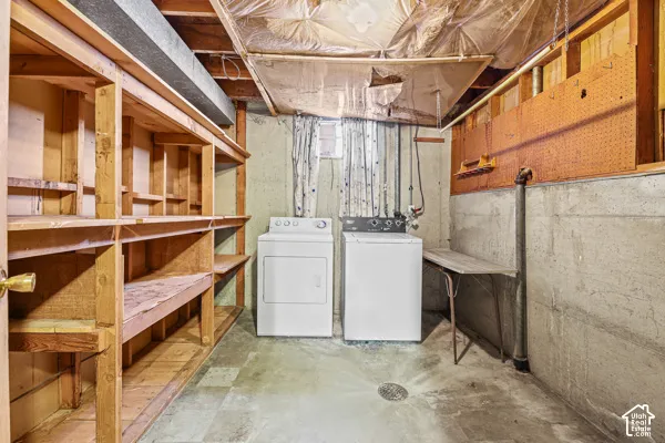 Laundry area featuring concrete flooring and a floor drain