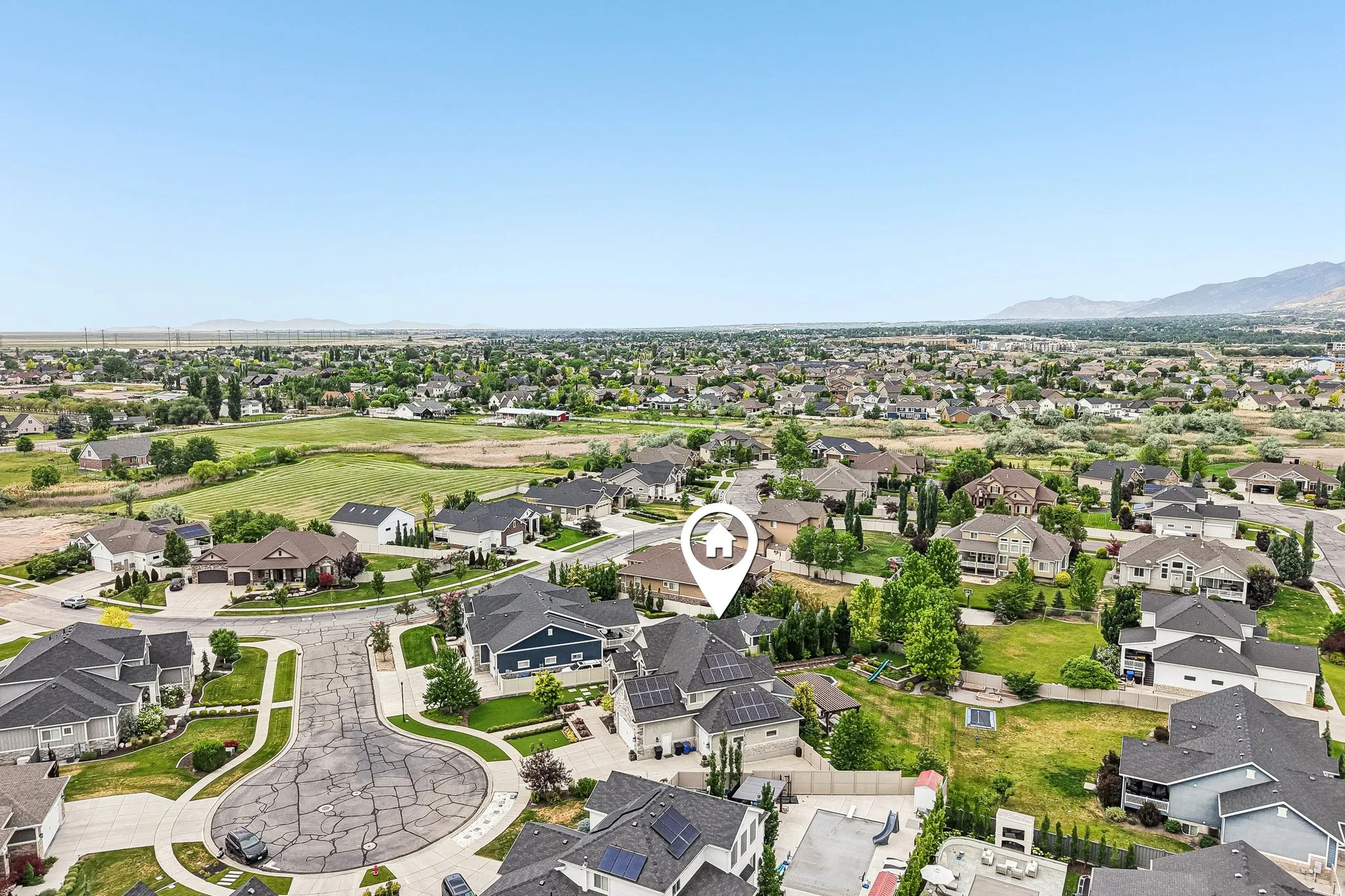 Aerial perspective showcasing a residential neighborhood with distant mountain ranges
