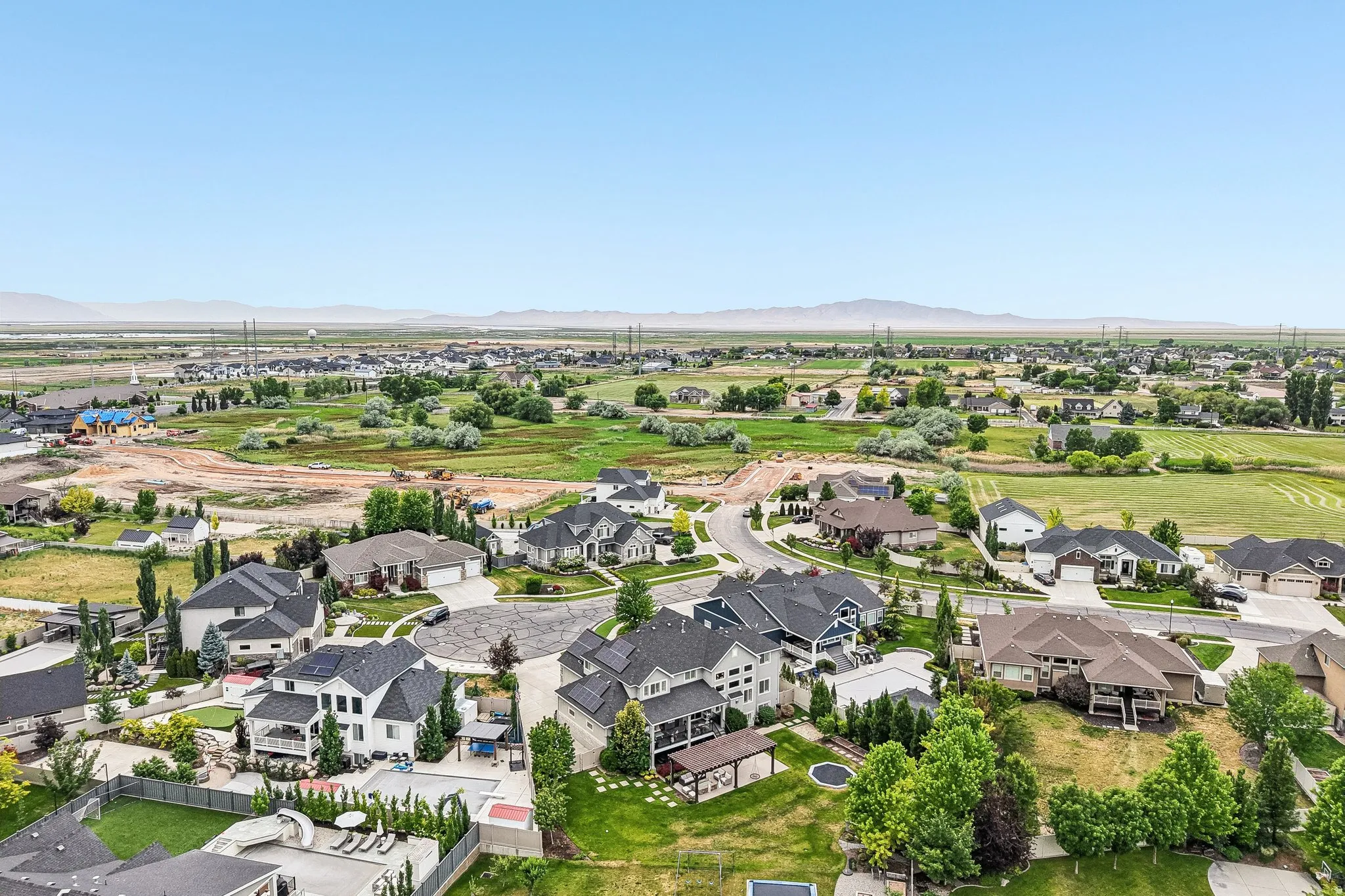 Aerial perspective showcasing a residential development with varied architectural styles and extensive green spaces