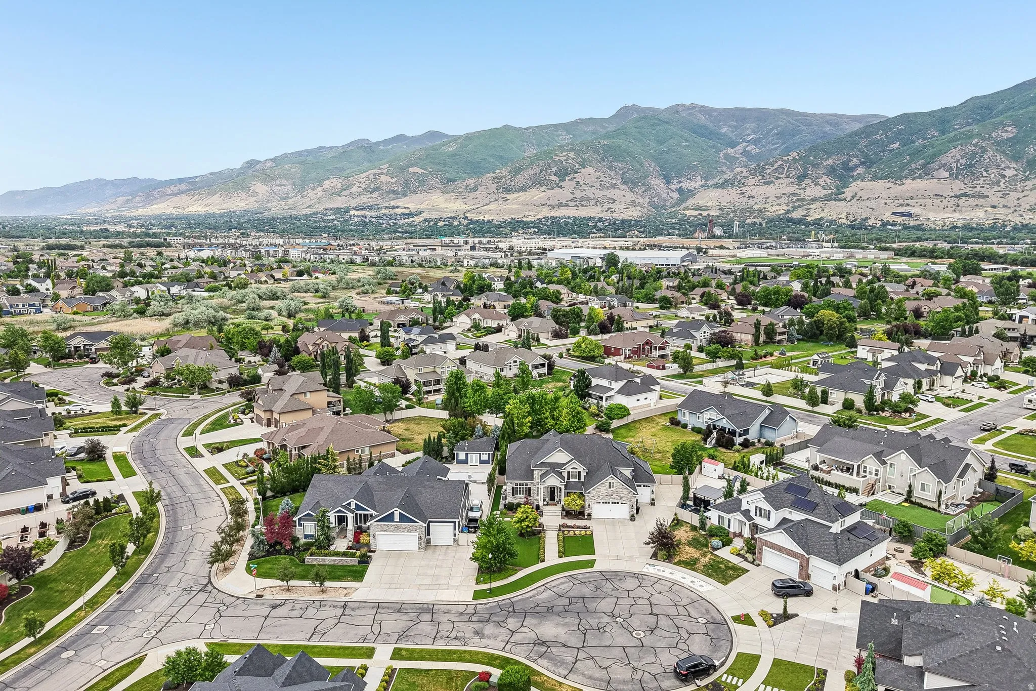Expansive residential community featuring a variety of architectural styles, mature landscaping, and mountain backdrops