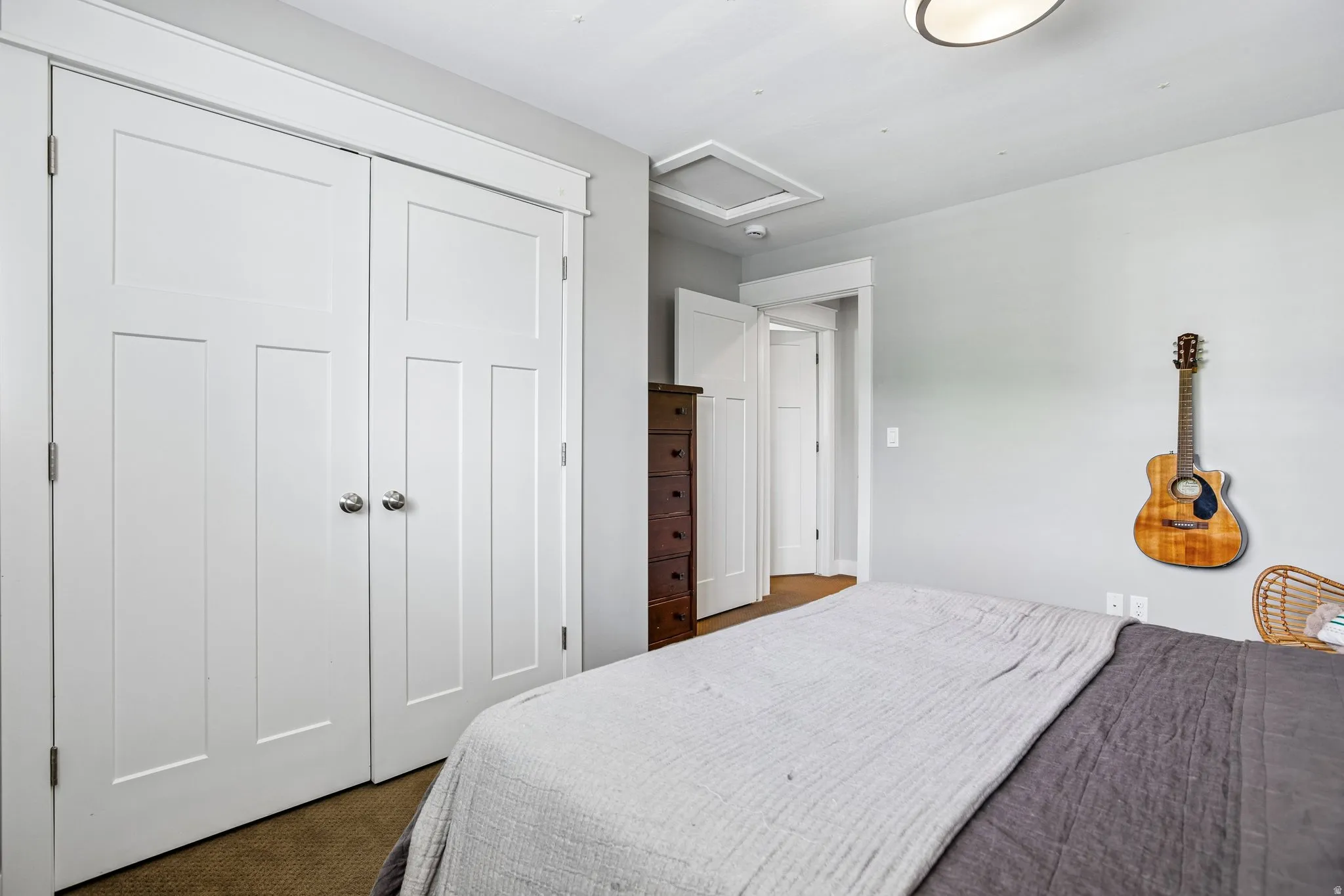 White paneled bi-fold closet doors with chrome hardware