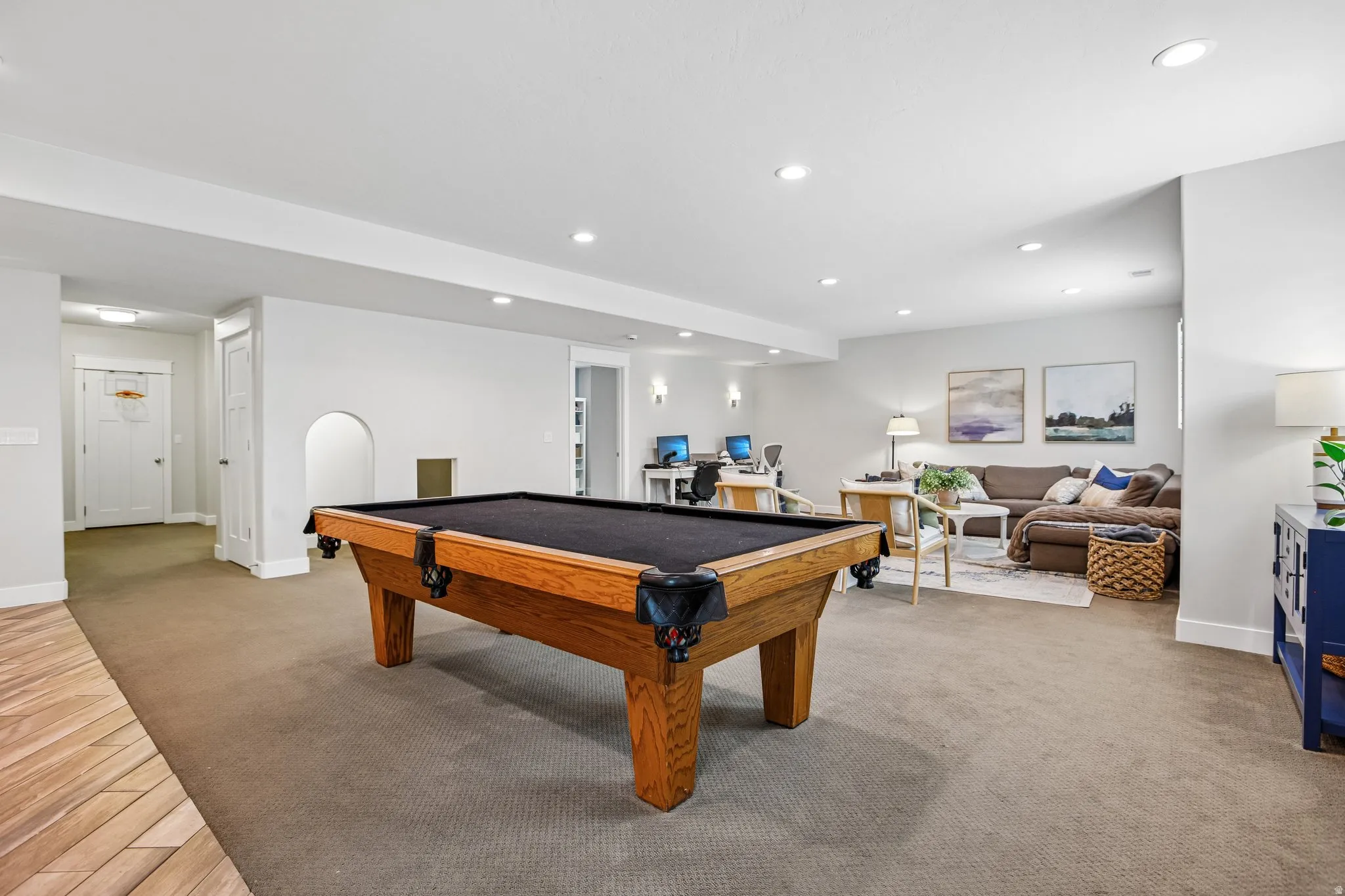 Spacious lower-level entertainment area featuring recessed lighting