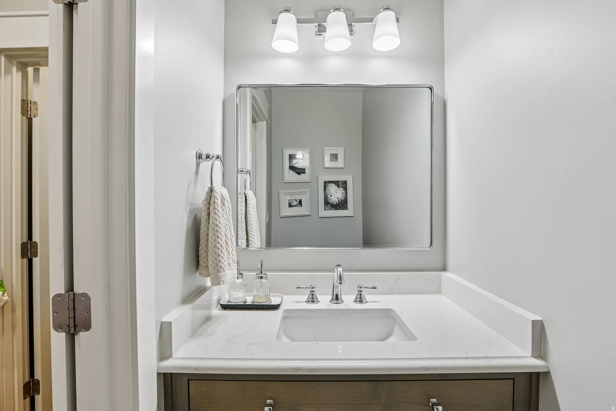Vanity with a quartz countertop and integrated rectangular sink
