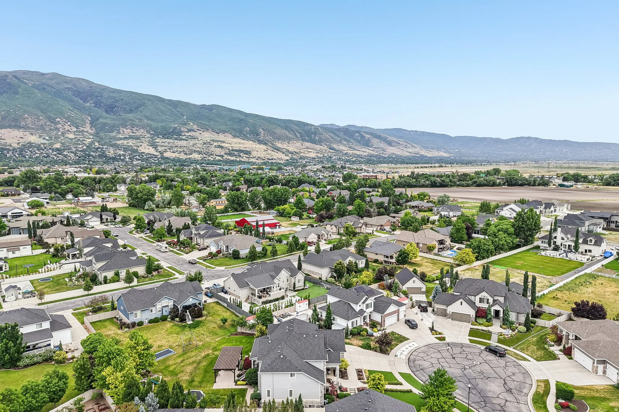 Residential neighborhood featuring mature trees, paved streets, and cul-de-sac designs