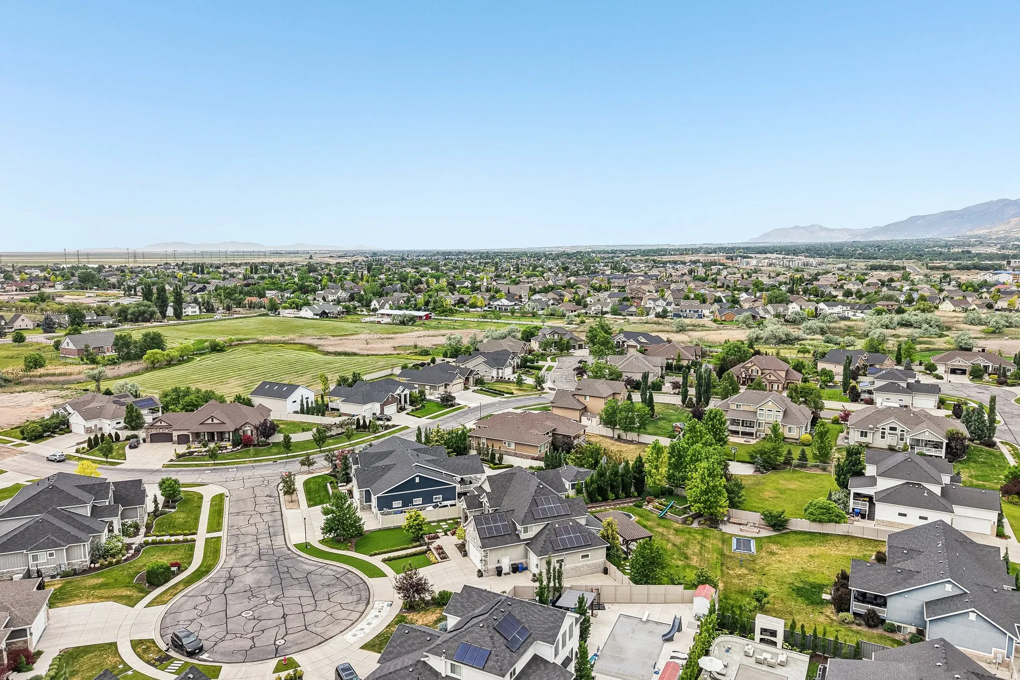 Aerial perspective showcasing a residential community with varied home styles and expansive green spaces
