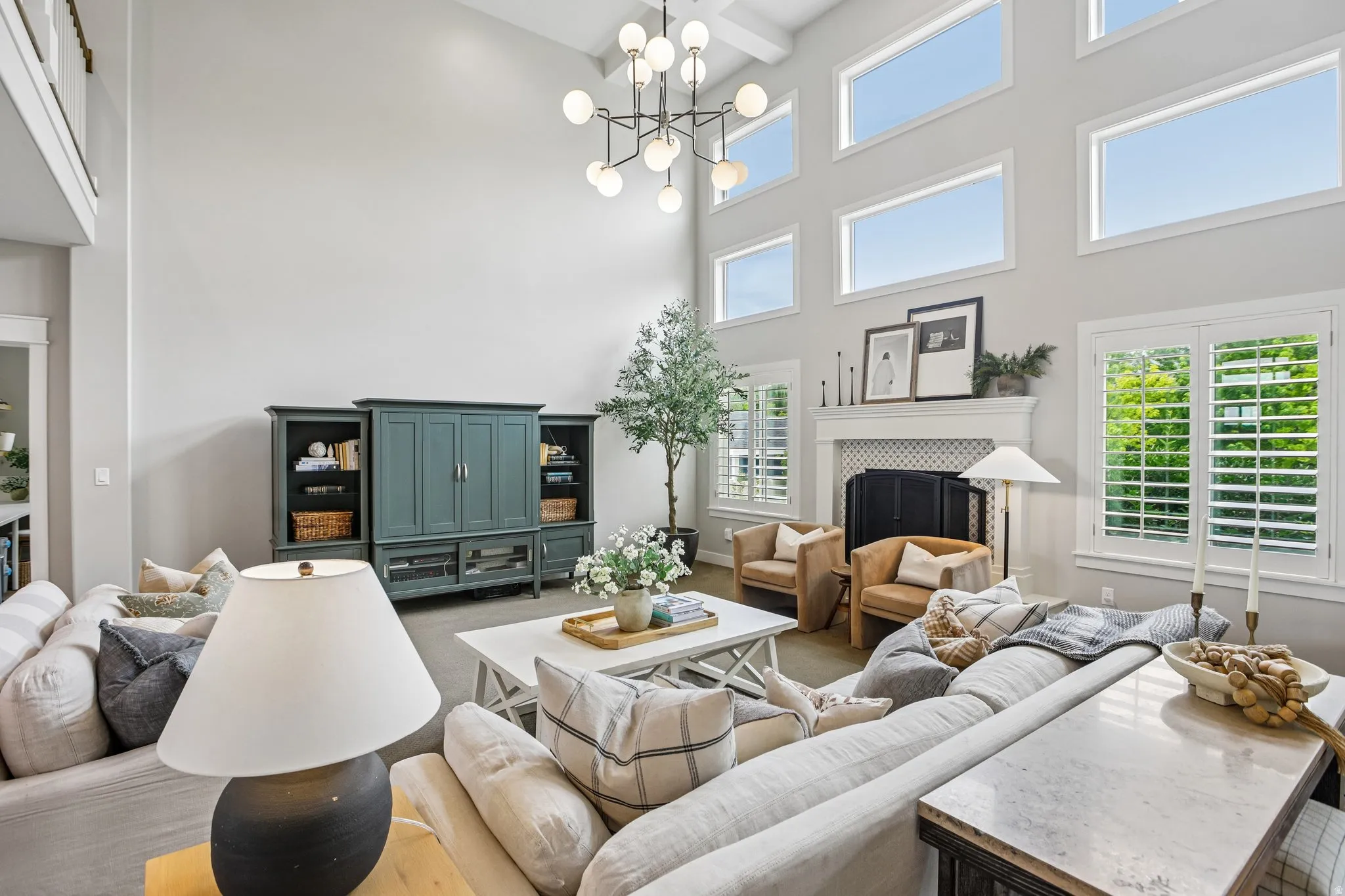 Spacious living area featuring a vaulted ceiling and an array of upper transom windows
