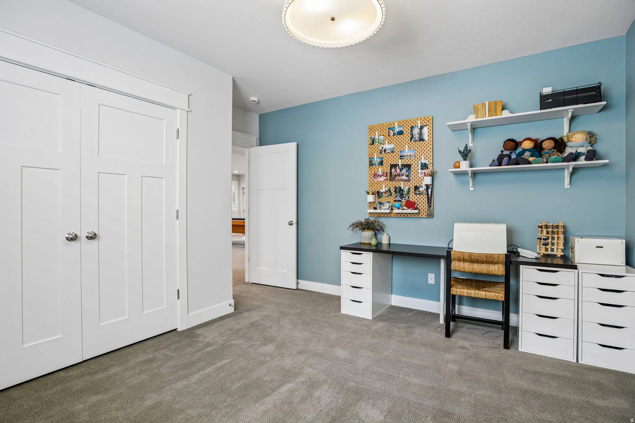 Spacious room featuring neutral carpet flooring, a light blue accent wall, recessed lighting, and white trim
