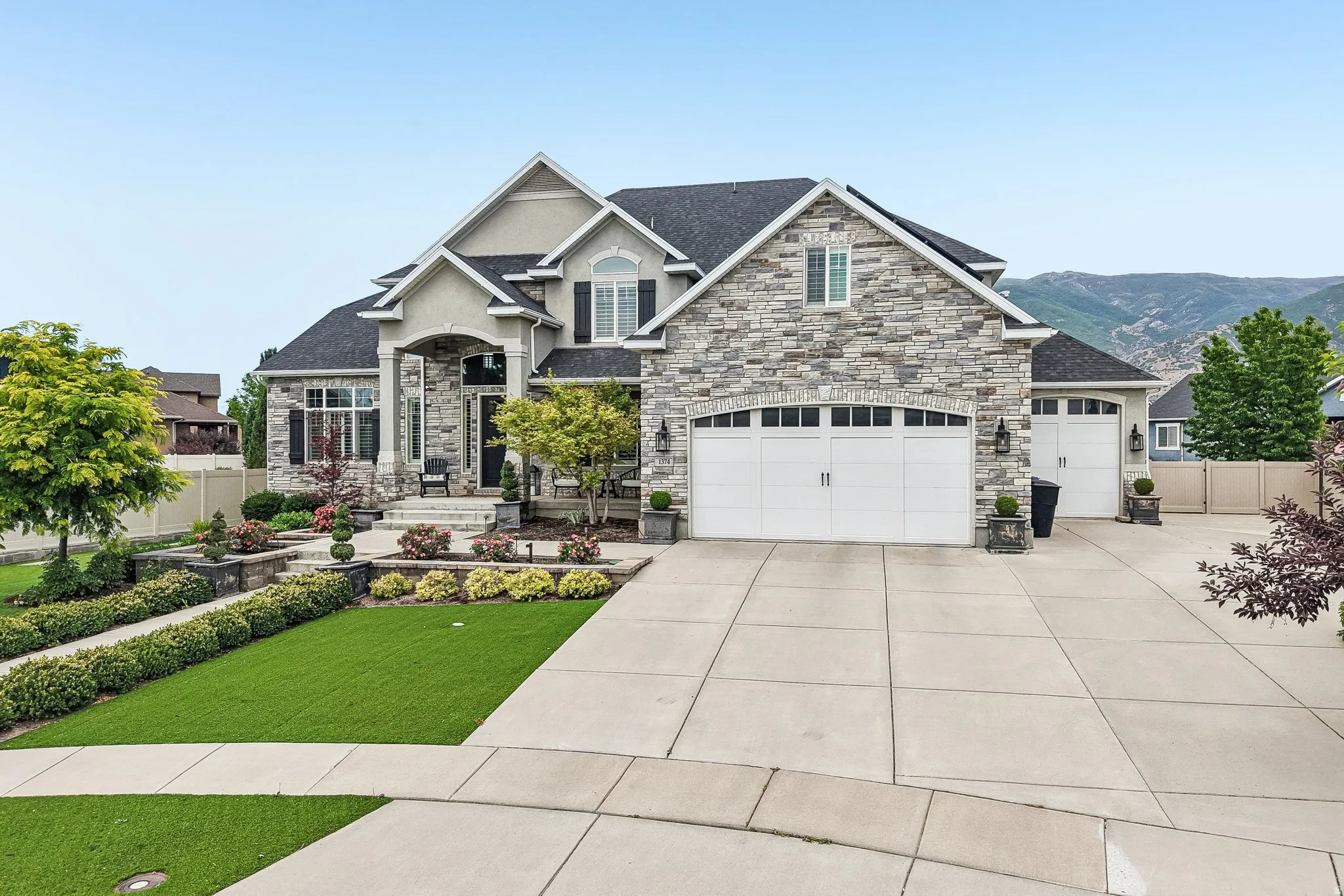 Stone veneer exterior with dark shingle roofing