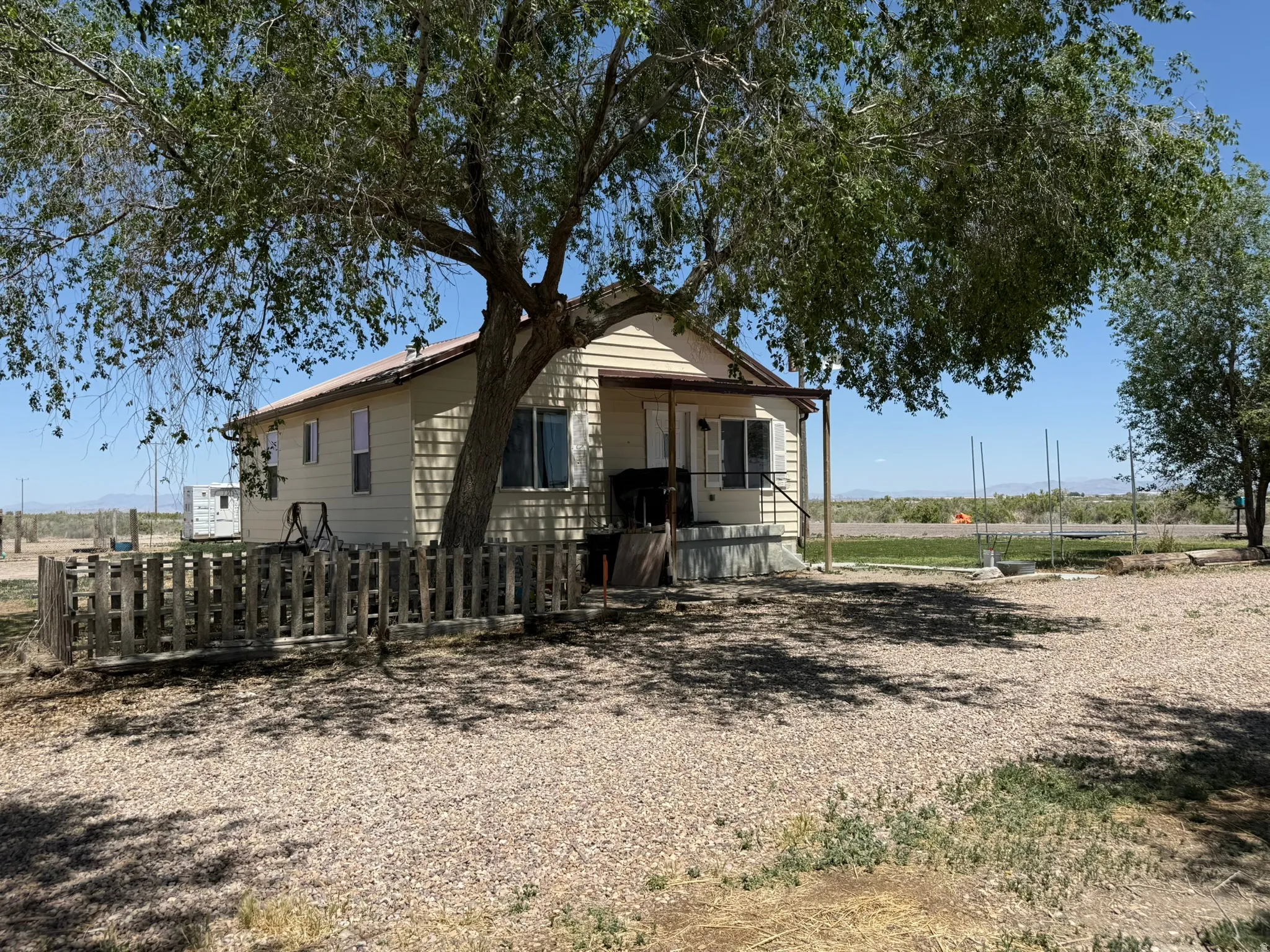 Ranch-style exterior with light-colored siding and a covered porch