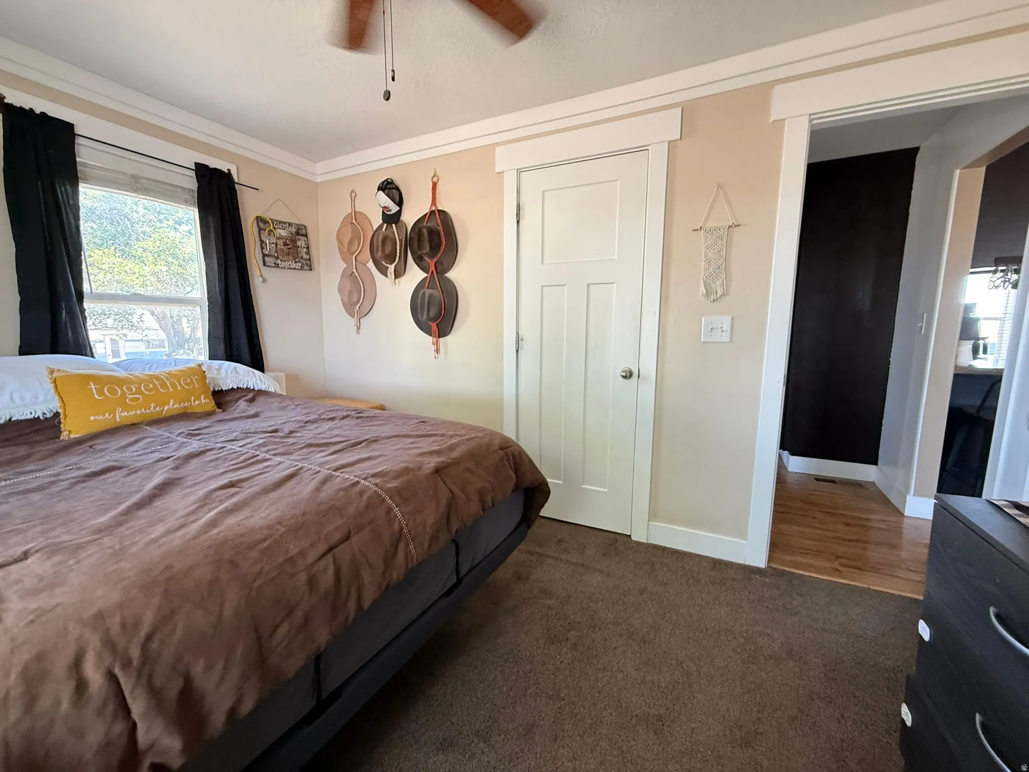 Neutral tone wall color with white trim and a ceiling fan