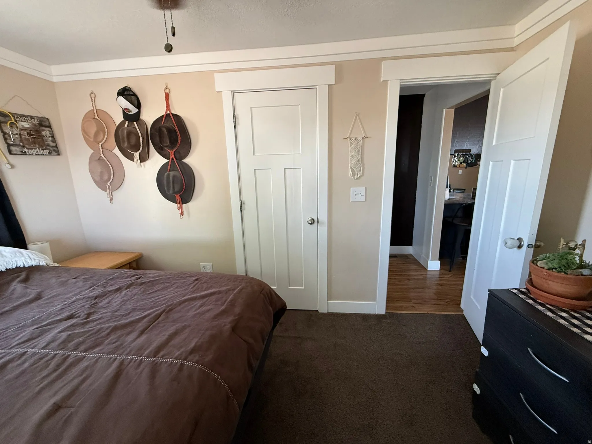Bedroom featuring neutral wall paint, white crown molding, and white trim around doorways