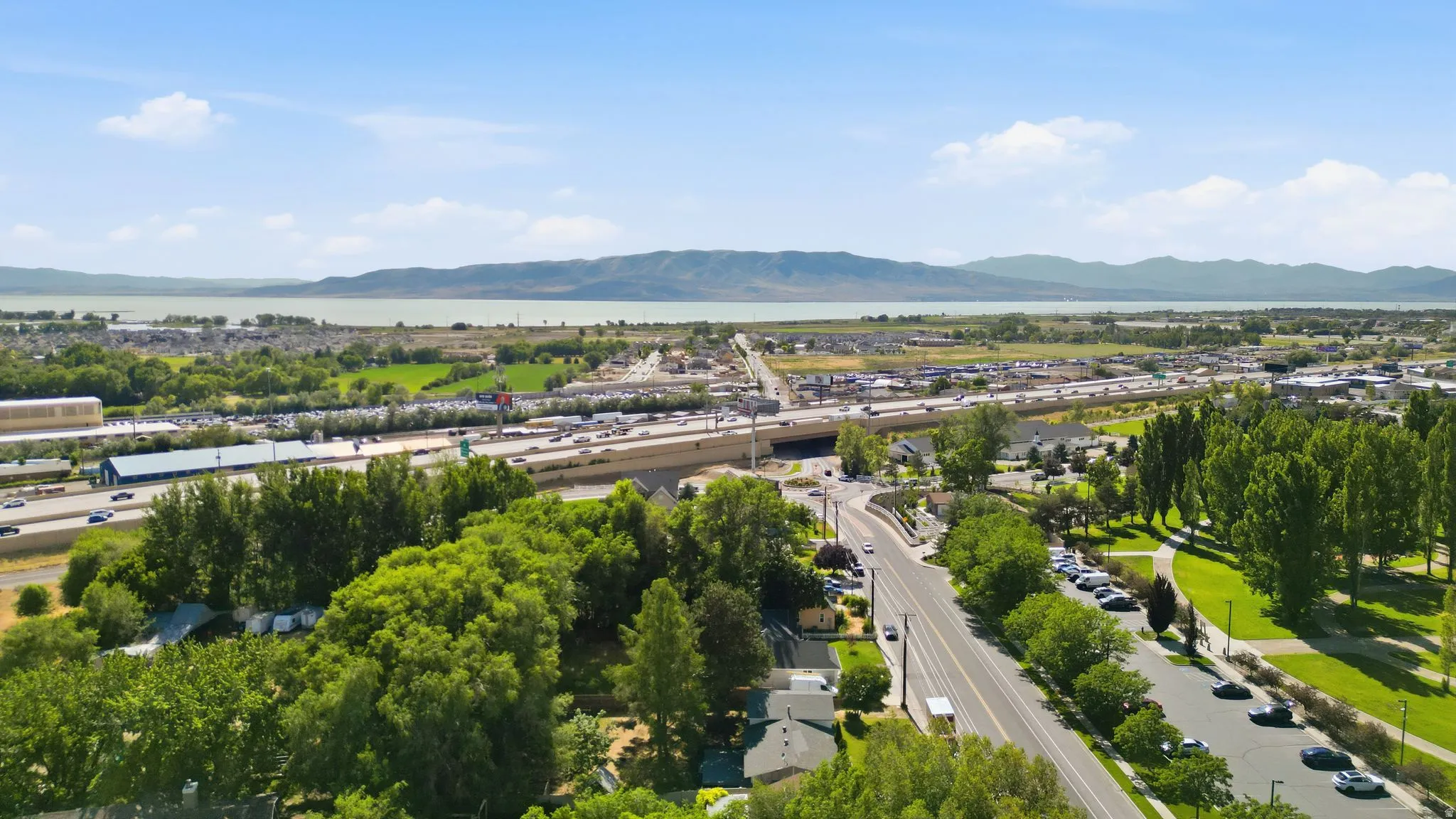 Aerial perspective showcasing an expansive regional landscape with a body of water in the distance