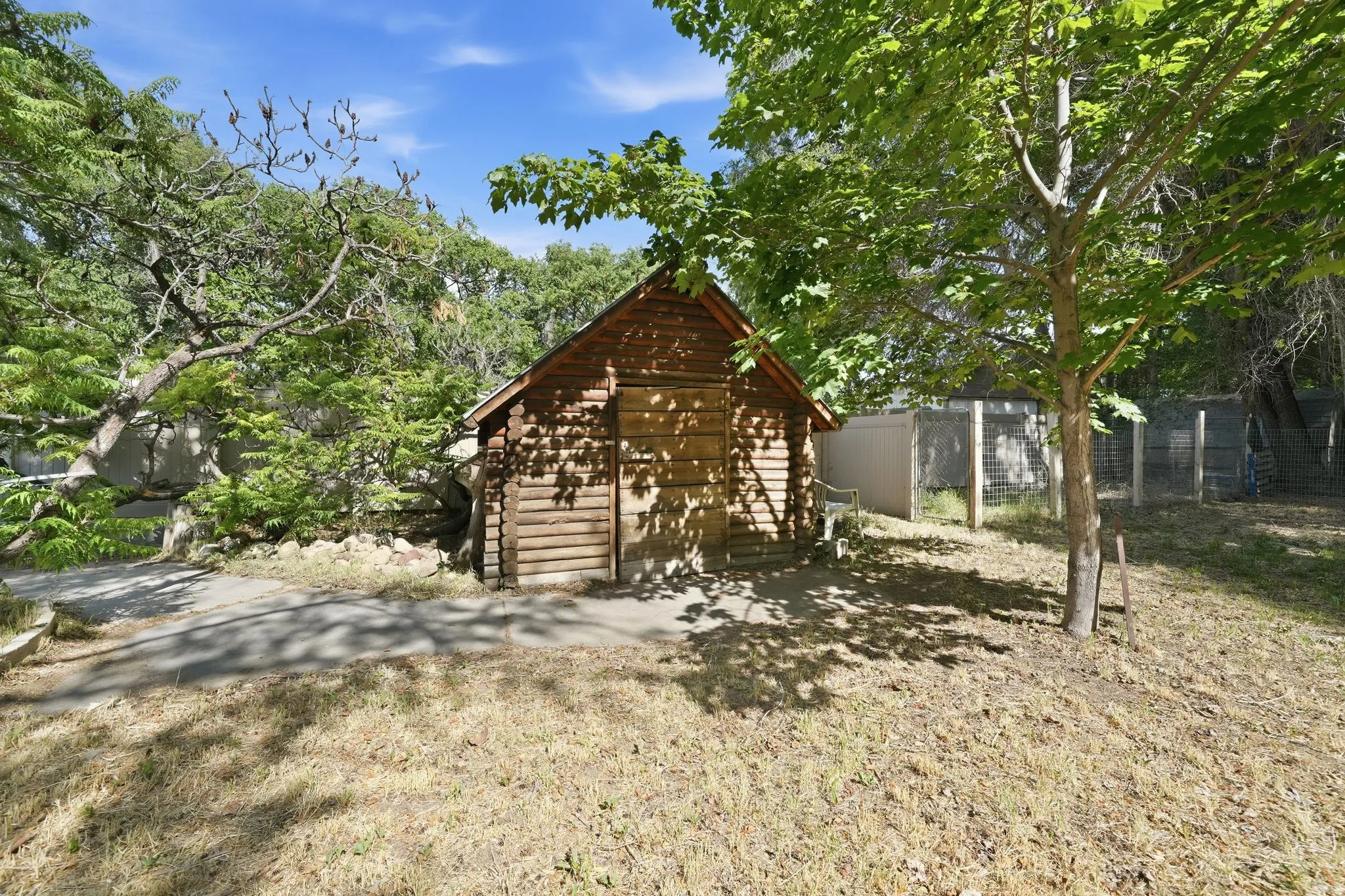 Wood-sided outbuilding featuring a sloped roof and a single-entry door