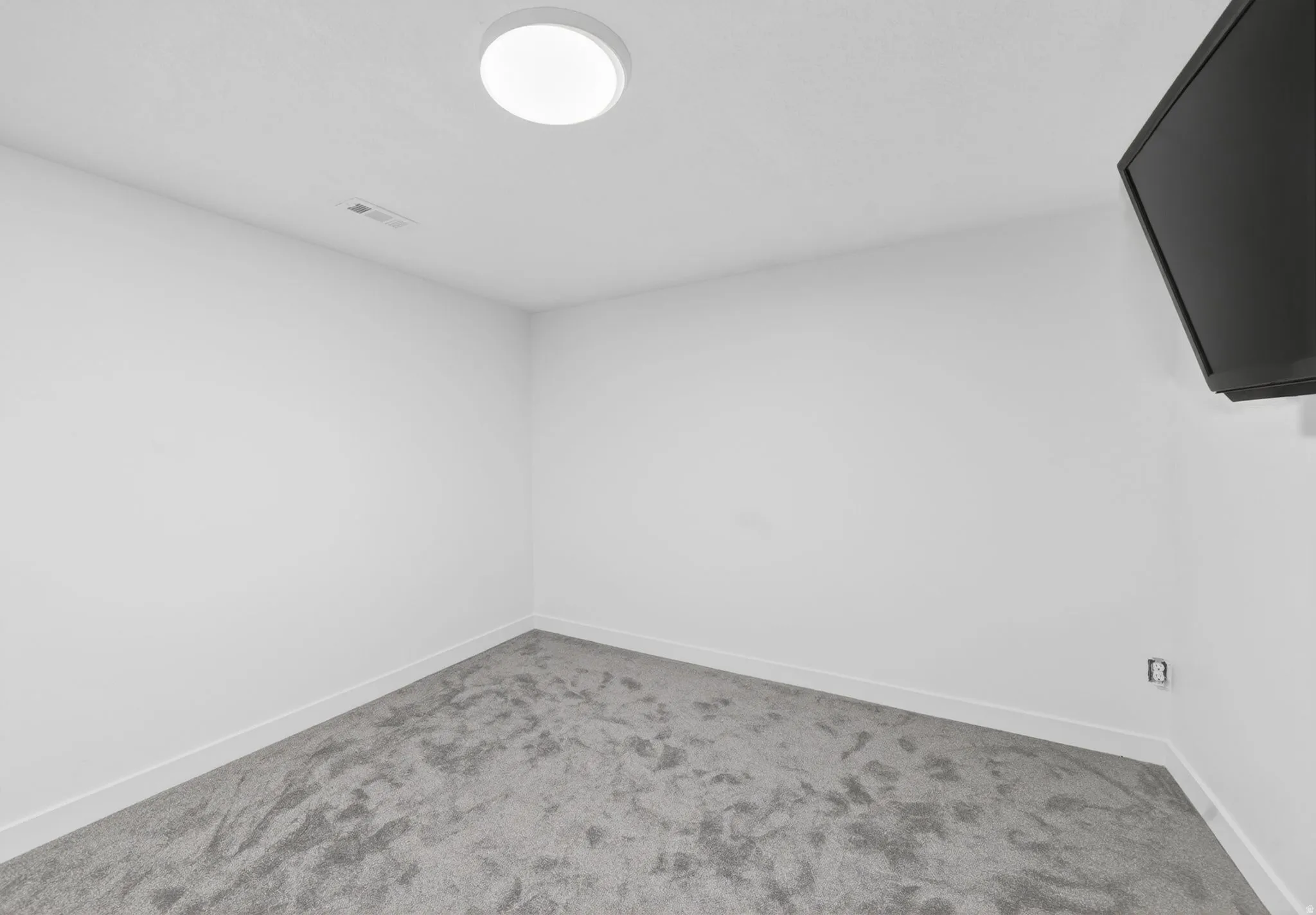 Neutral white walls with gray carpeting