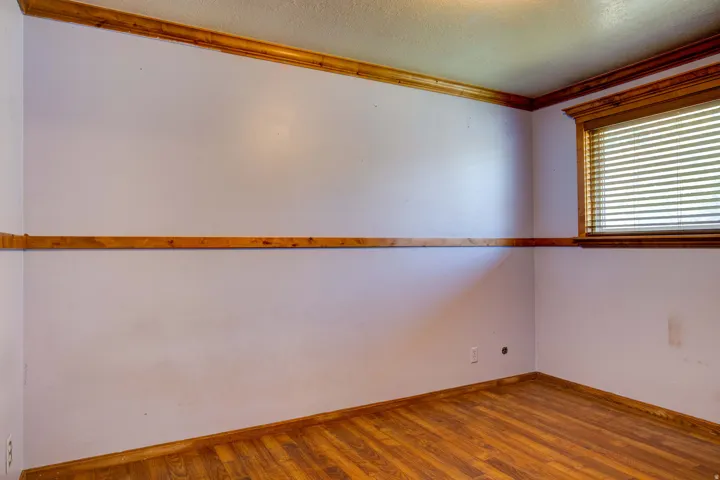 Wood-finish flooring with coordinating wood trim and window casing