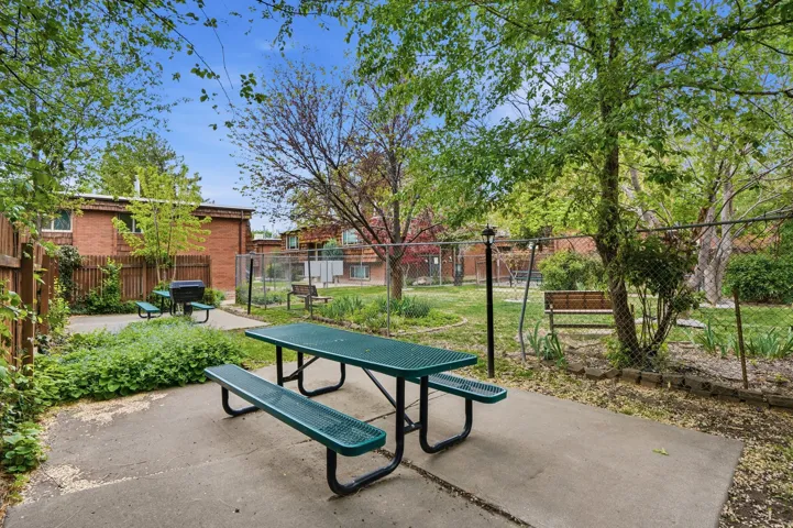 Outdoor patio space featuring a picnic table with benches