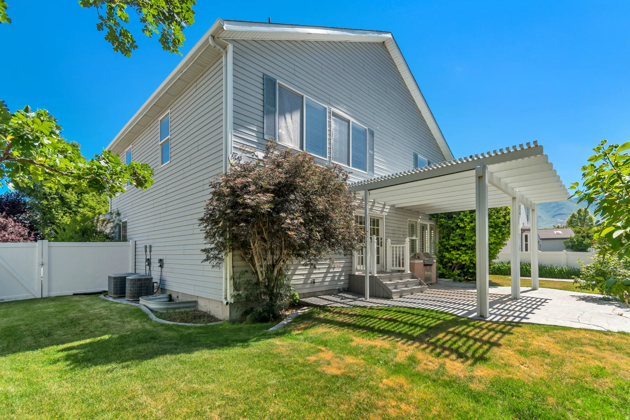 Two-story exterior with light gray siding and white trim