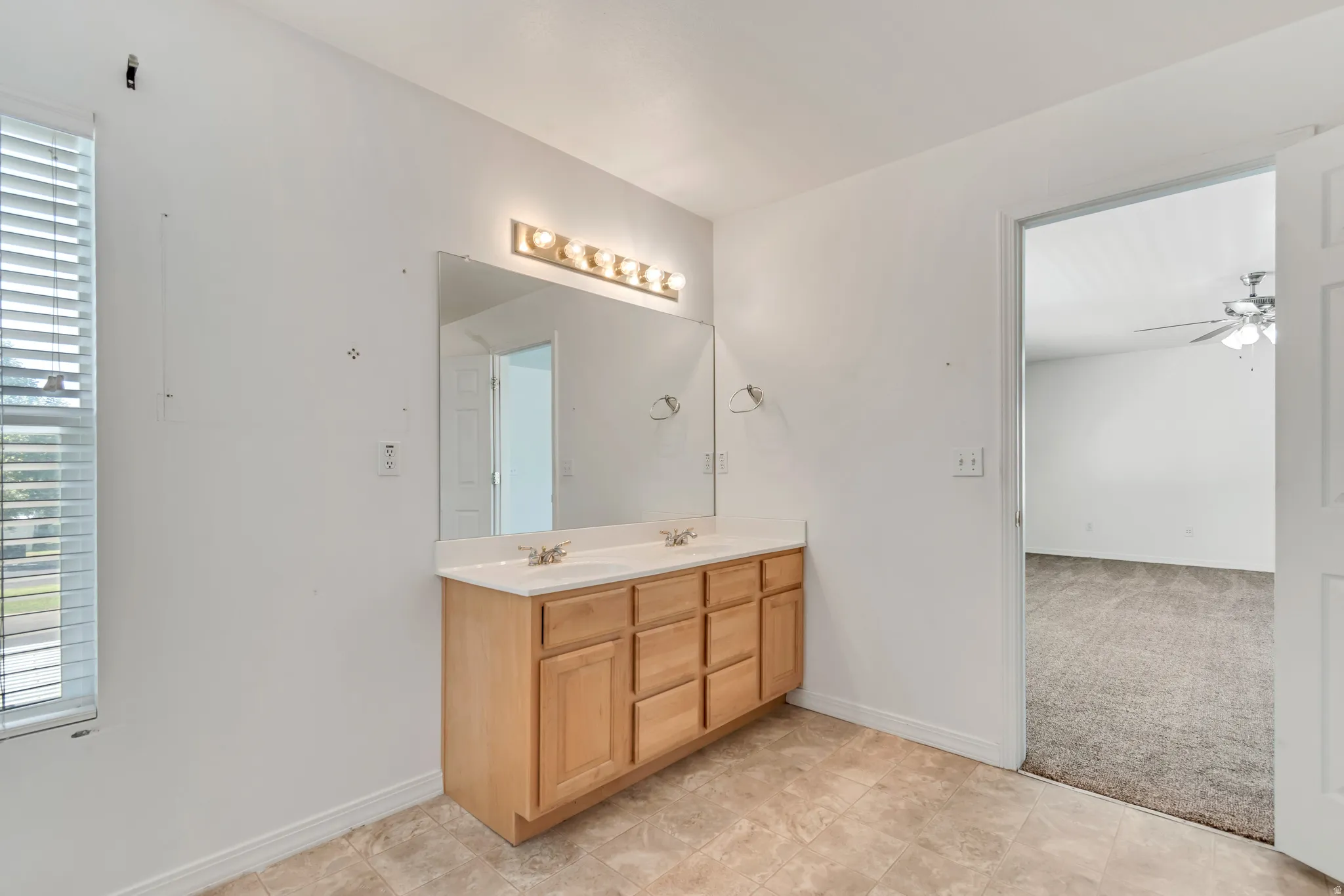 Master bathroom with double vanity and a large wall-mounted mirror