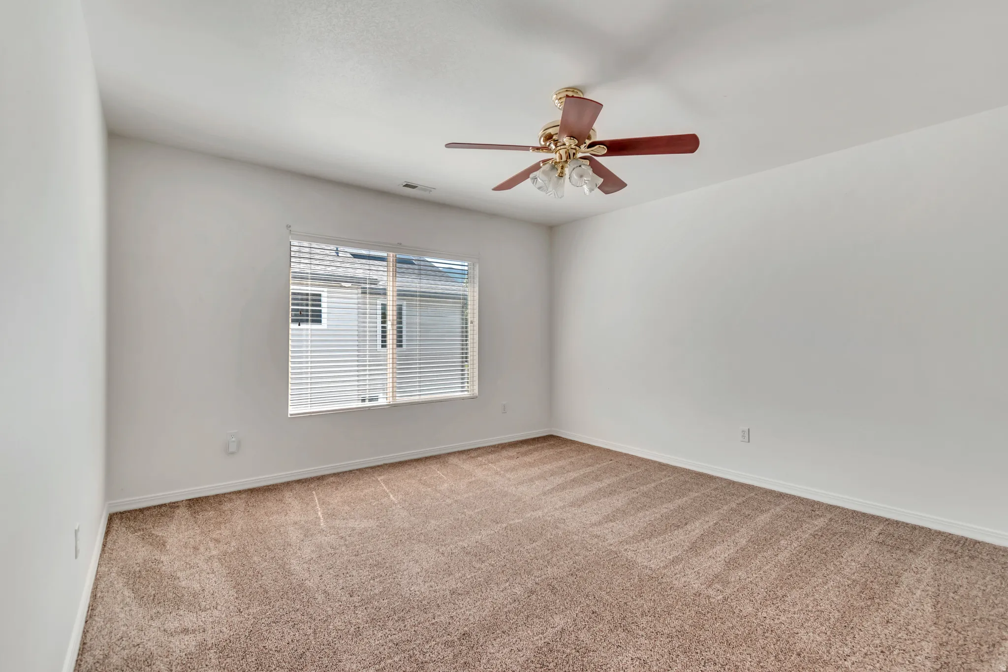 3rd Bedroom featuring neutral-toned carpet, white walls, and a ceiling fan with integrated lighting