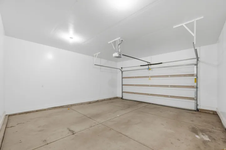 Spacious garage featuring a concrete floor and white finished walls.