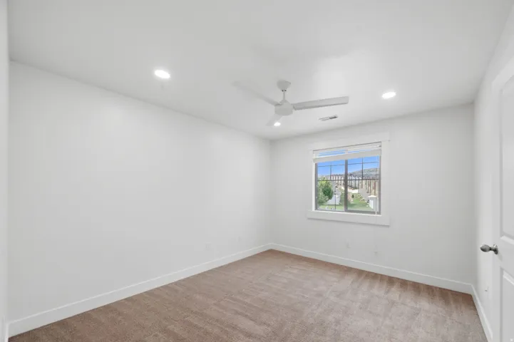 Bedroom #3 with a ceiling fan, recessed lighting and walk-in closet