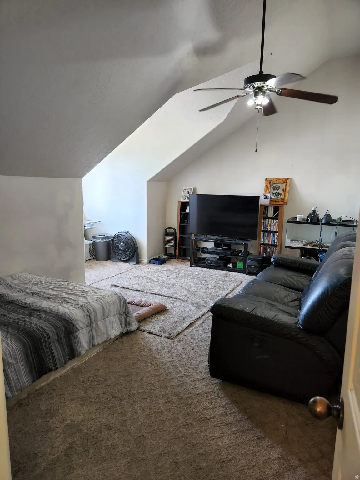 Extra large 4th bedroom with carpet, sloped ceilings and a ceiling fan with light fixture