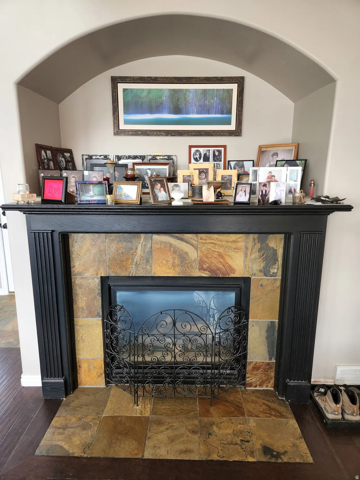 Gas Fireplace with a black mantel and slate tile surround