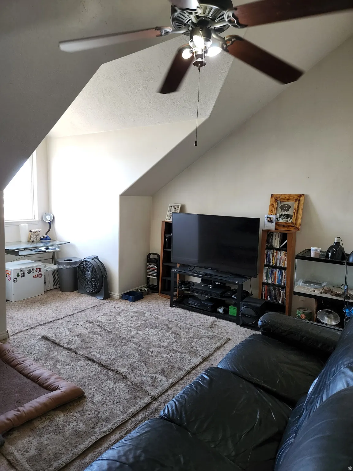 Extra large 4th bedroom. Carpeted room with sloped ceilings and a ceiling fan