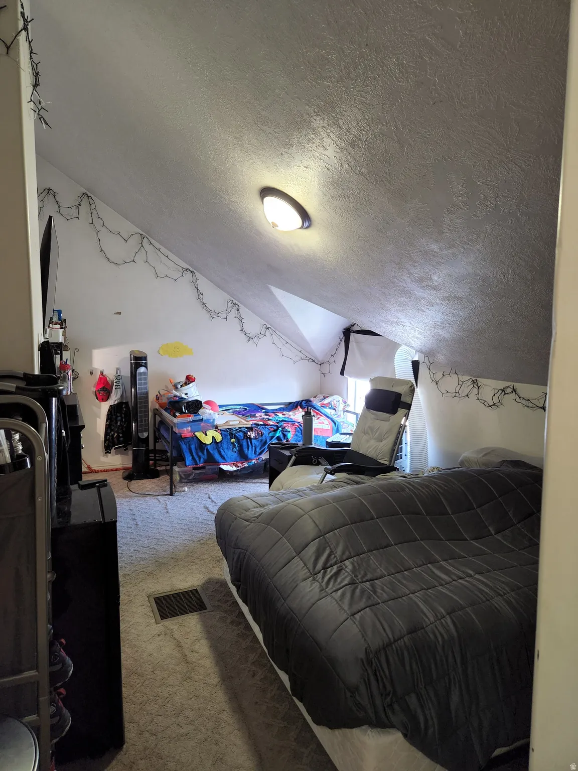 Extra large carpeted 5th bedroom room featuring a sloped ceiling, recessed lighting, and a floor vent