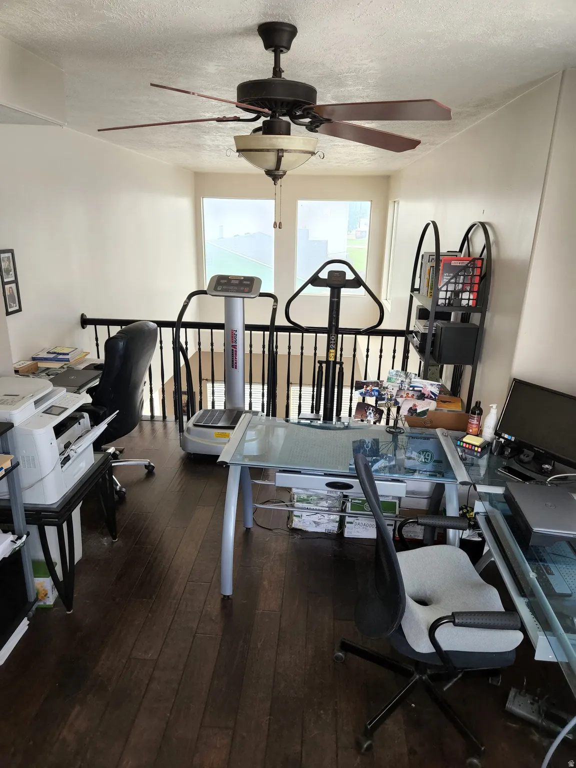 2nd floor Loft area featuring wood-finish flooring, a ceiling fan with integrated lighting, and a black railing
