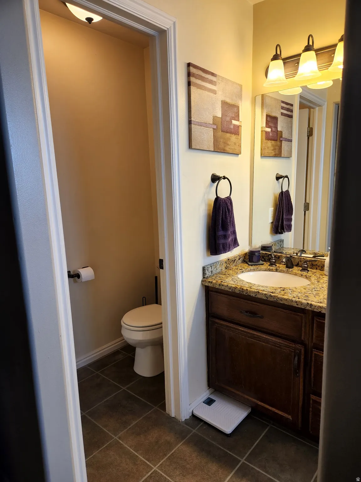 Master Bathroom featuring a dark wood vanity with a stone countertop and sink