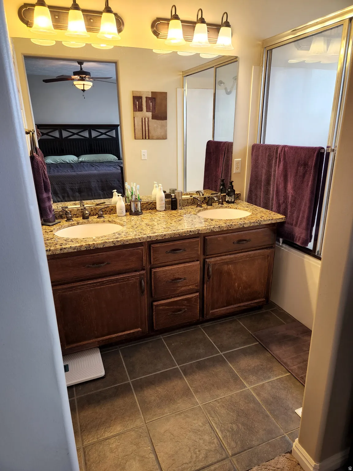 Master Bathroom with Double vanity with granite-style countertop and integrated sinks