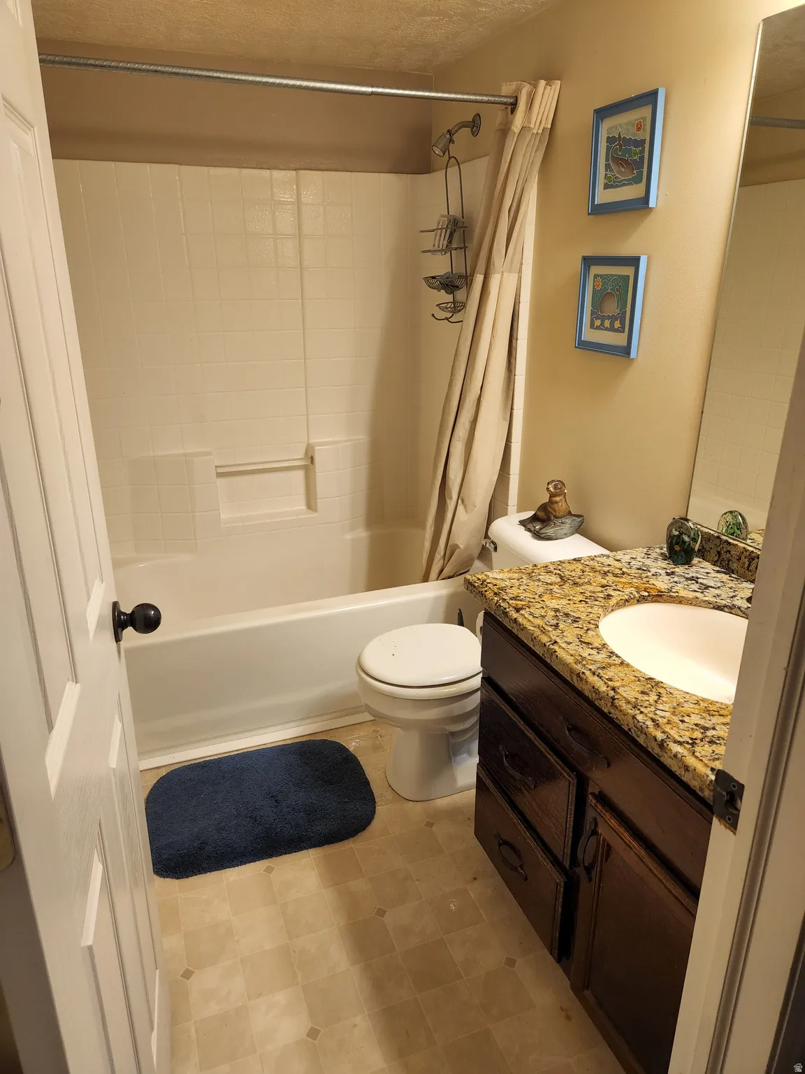 Second floor hall Bathroom featuring a white bathtub, a toilet, a vanity with a granite-style countertop, an integrated sink, and dark wood-finish cabinetry