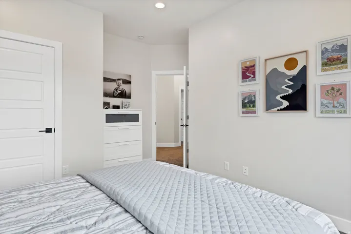 Spacious interior room with light-colored walls and recessed ceiling lighting