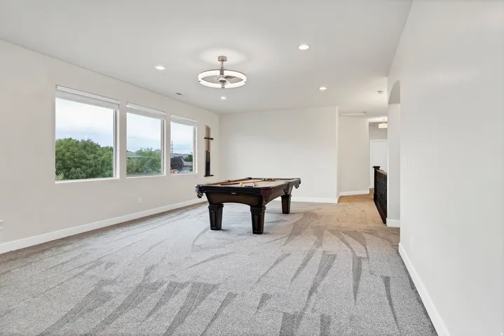 Spacious bonus room featuring three large windows, recessed lighting, and a contemporary ceiling fan