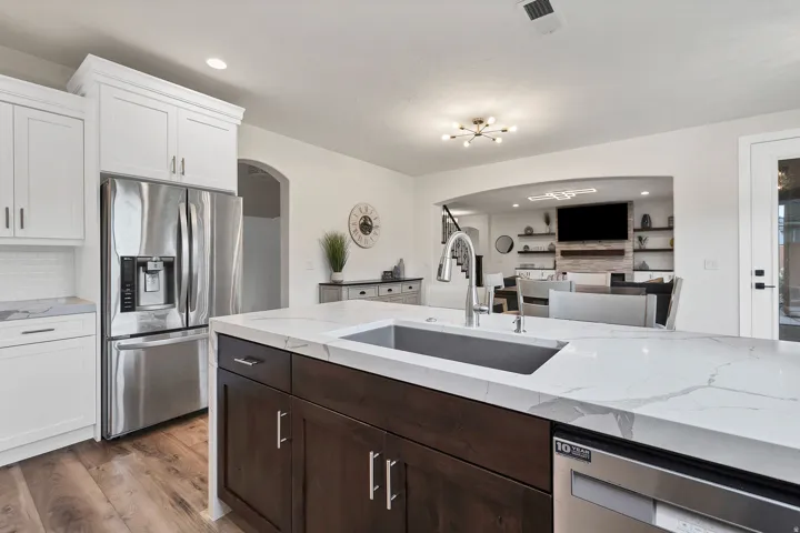Kitchen island featuring a single-basin undermount sink with a gooseneck faucet