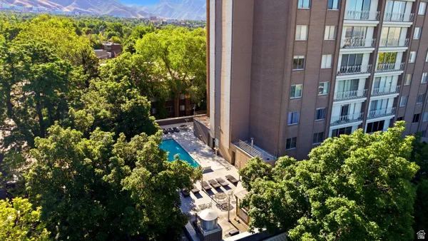 High-rise residential building featuring a brick facade and multiple balconies