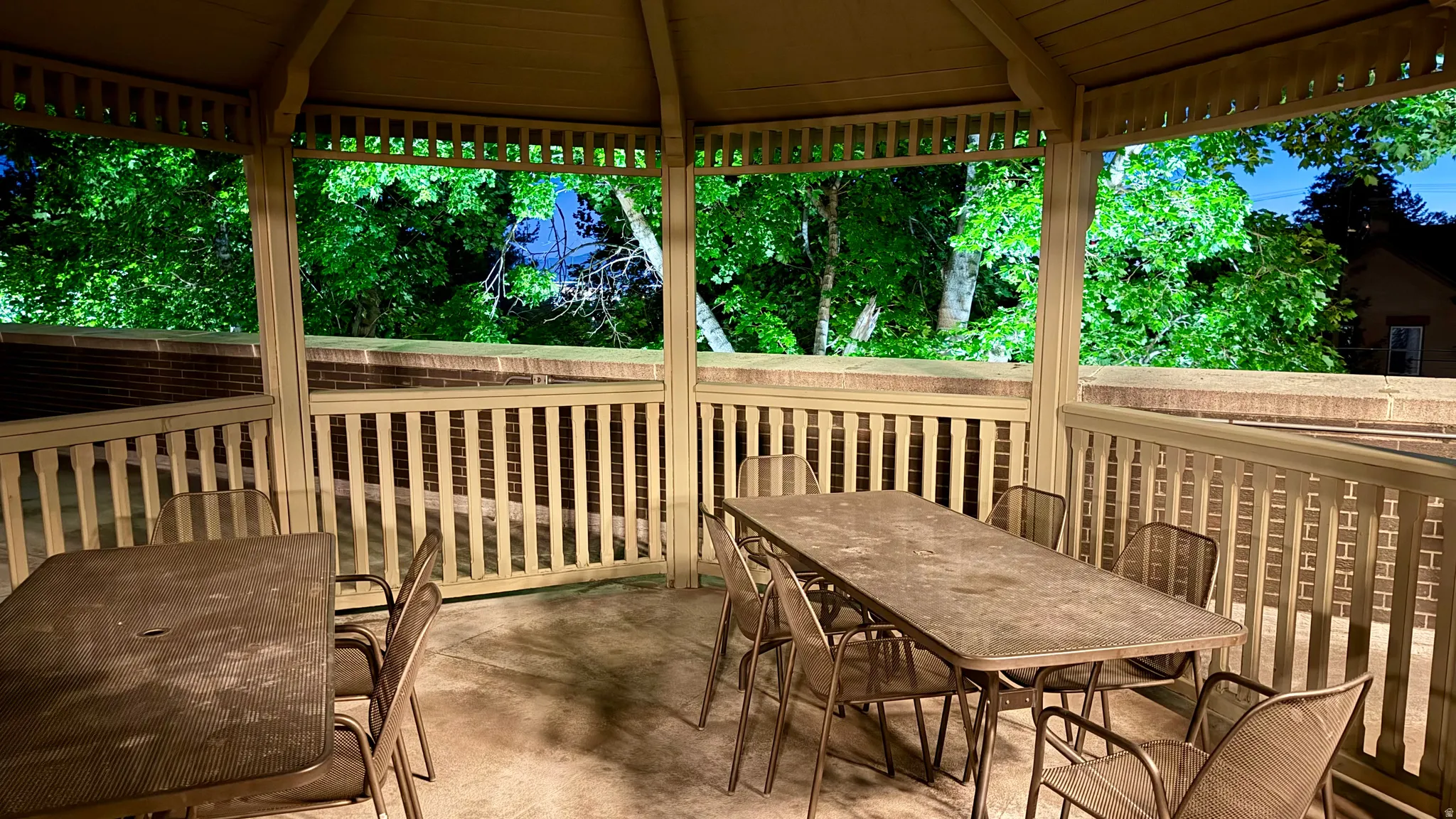 Gazebo structure featuring open-slat railings and an open lattice ceiling