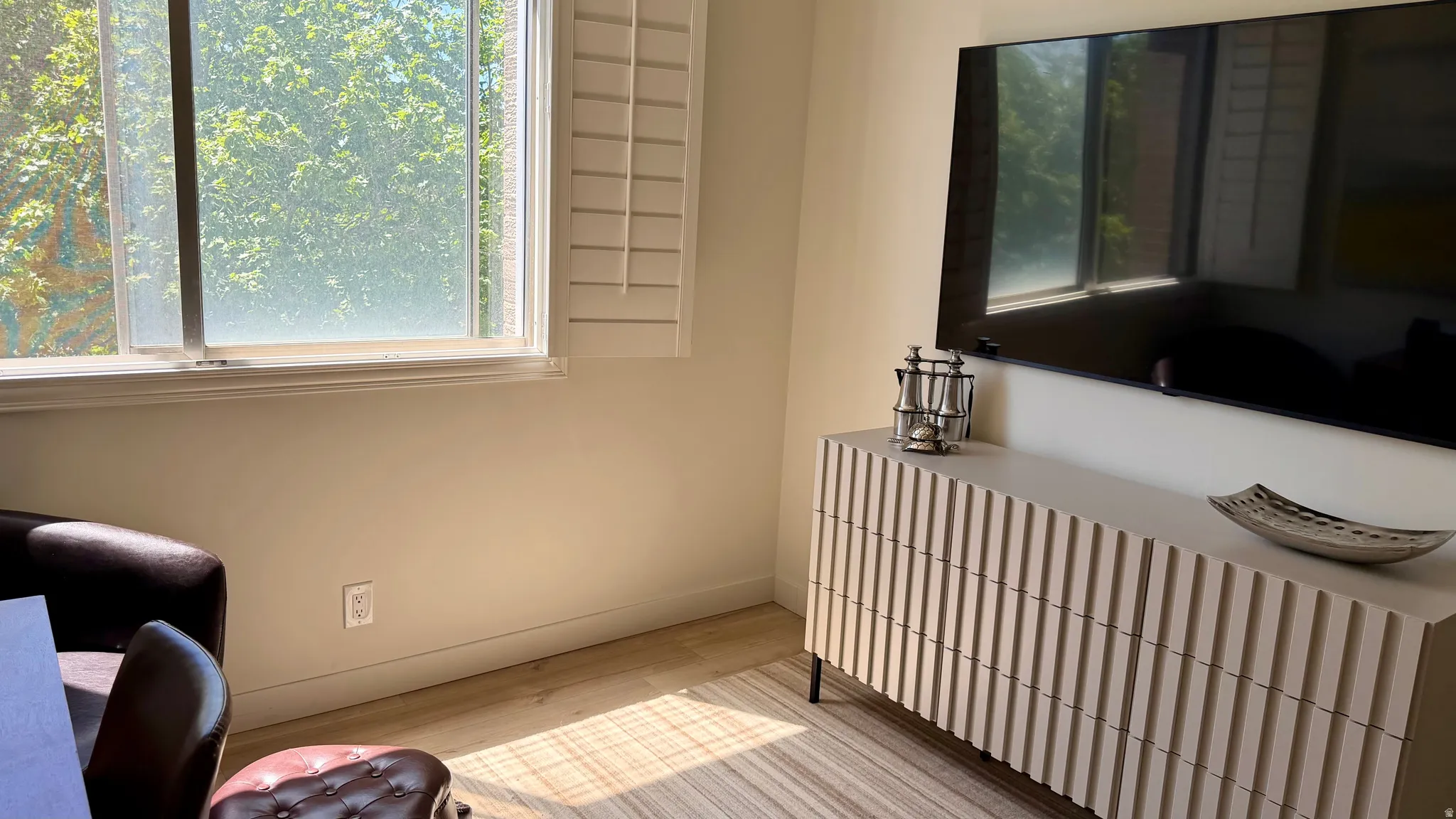 Light wood-finish flooring complements neutral wall tones