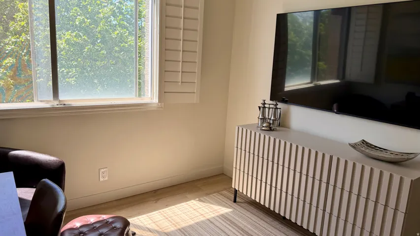 Light wood-finish flooring complements neutral wall tones