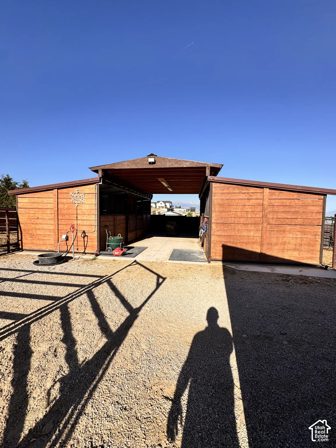 Wood-paneled outbuilding with a central breezeway and two covered wings