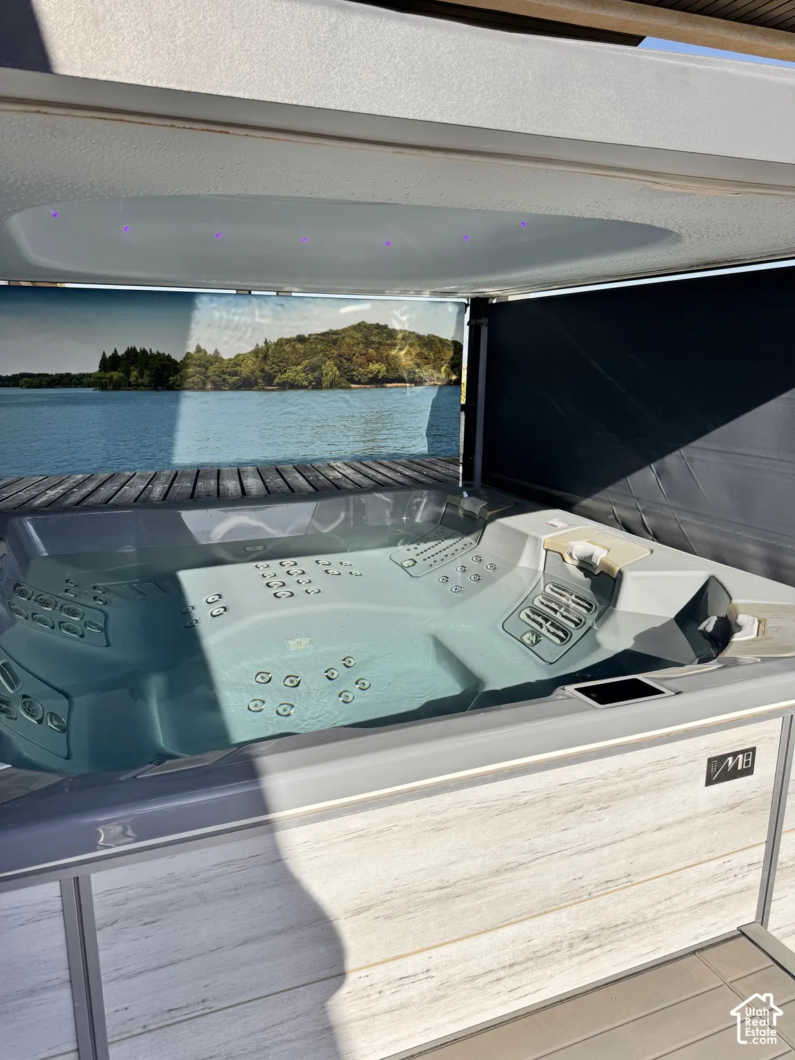 Integrated spa tub with a multi-jet design, interior lighting, and a wood-finish surround